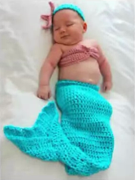 Ashley’s baby girl sleeping in a turquoise crocheted mermaid outfit