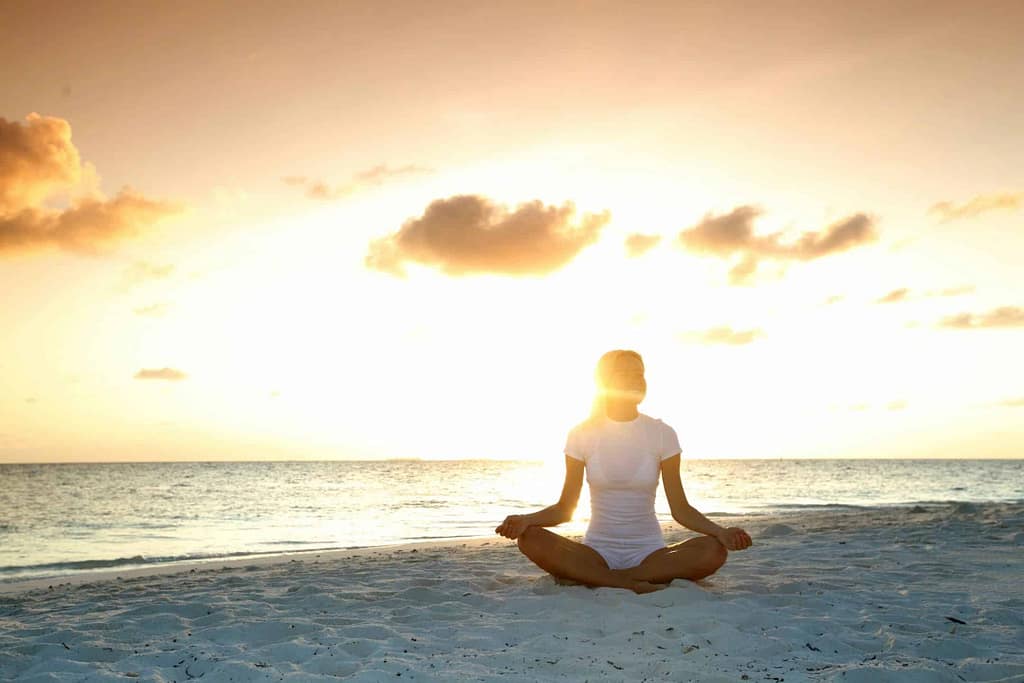 A quiet moment of yoga beside the ocean at sunset
